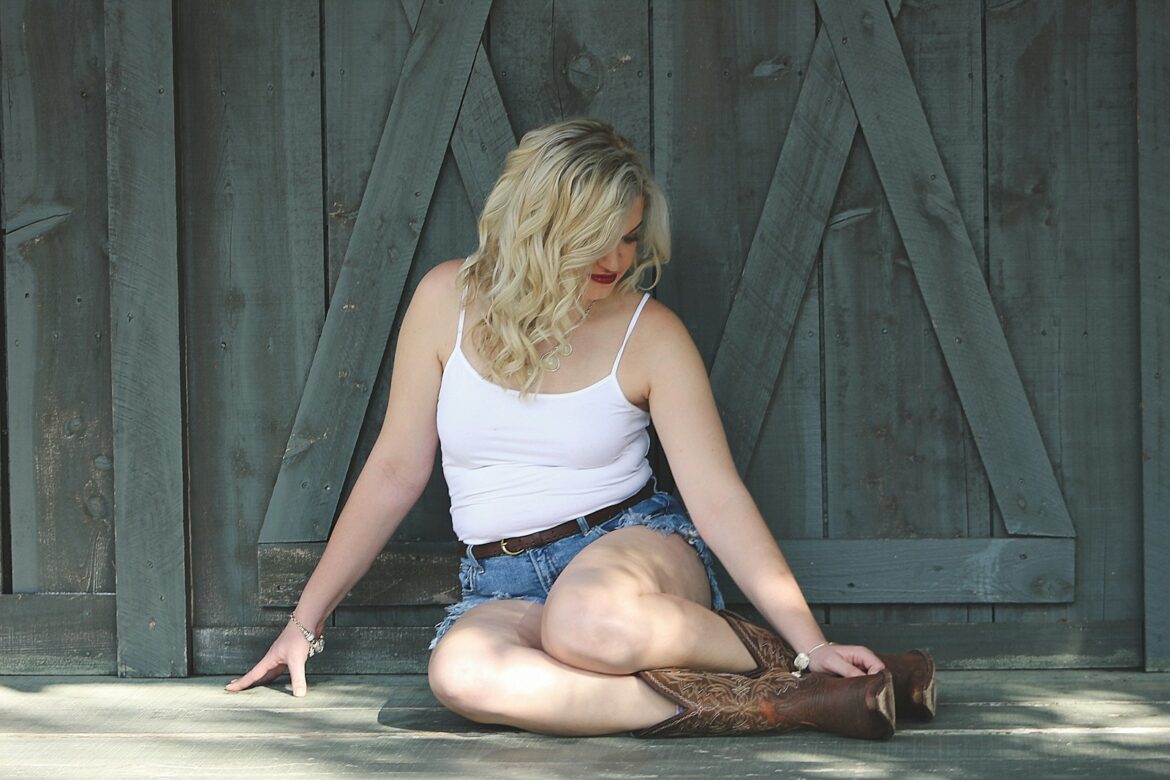 a woman sitting on the ground with her legs crossed
